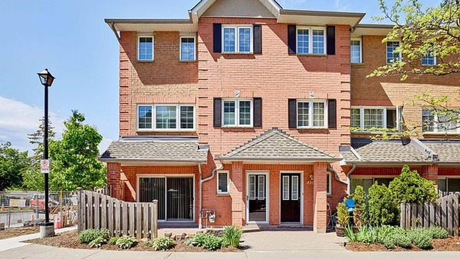 1400 The Esplanade N #411, Pickering, a red brick three-storey corner townhome in a gated Town Centre community, listed by The Gordon Brothers Team