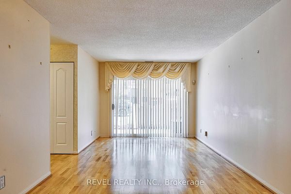 Living area with sliding-door walkout to the private terrace at 1400 The Esplanade N #411, Pickering, listed by The Gordon Brothers Team, Revel Realty Inc., Brokerage
