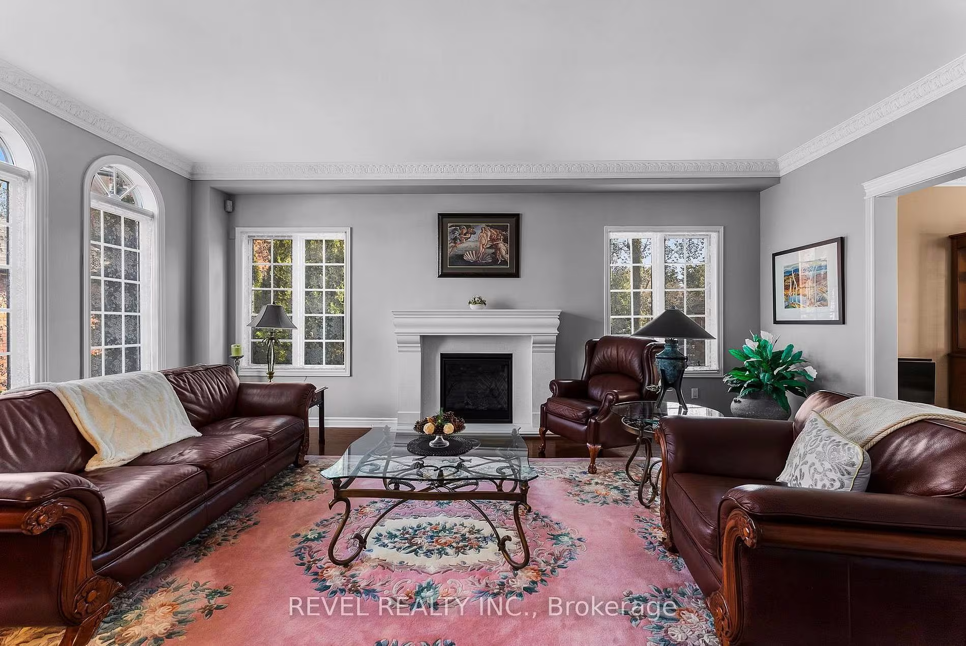 Formal living room with a fireplace and hardwood flooring at 1486 Ashwood Gate, Pickering, listed by The Gordon Brothers Team, Revel Realty Inc., Brokerage